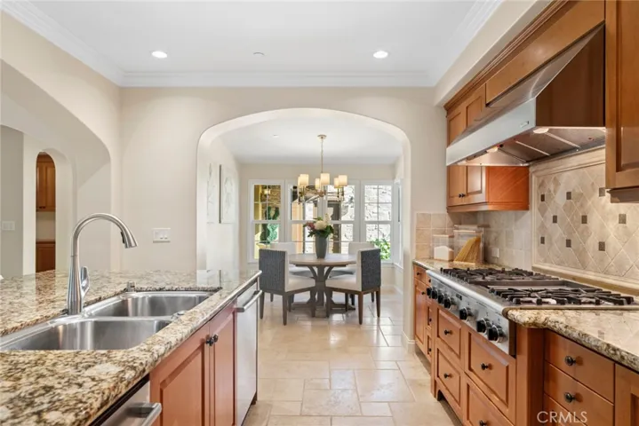 Kitchen with upgraded appliances facing kitchen eating nook