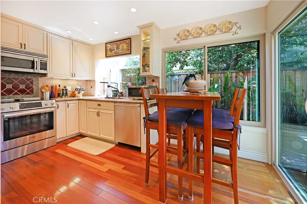 Open kitchen and dining space featuring generous cabinetry and excellent natural light