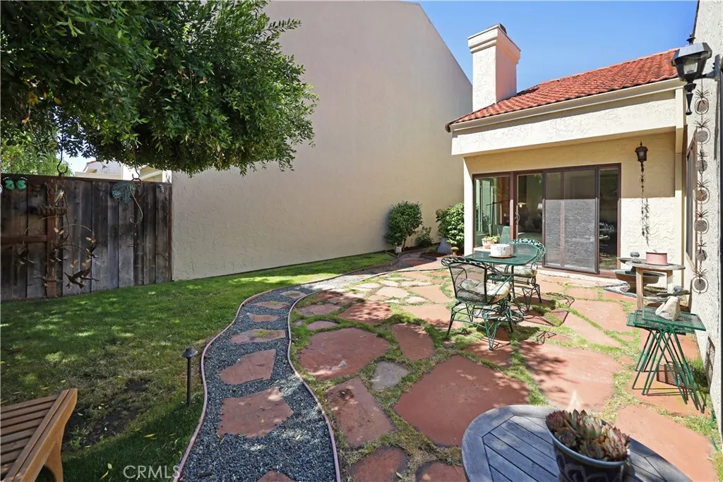 Backyard patio featuring low-maintenance landscaping and a covered area perfect for outdoor gatherings.