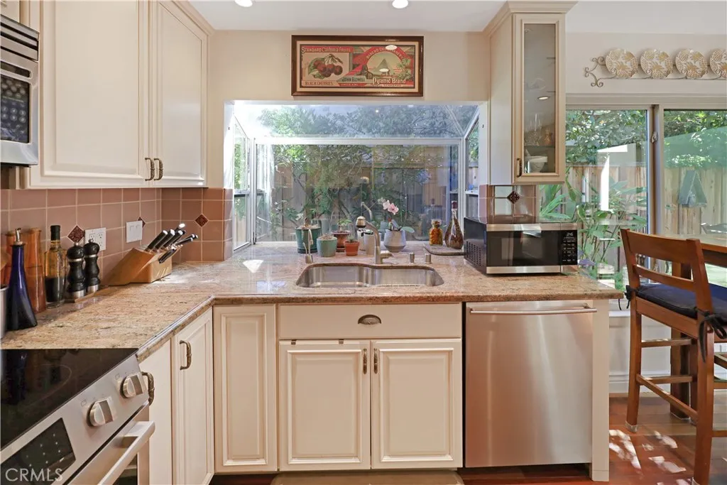 Kitchen view showcasing the functional workspace, breakfast bar, and easy access to the adjoining living areas.