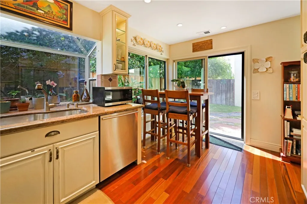Casual dining area opening to the backyard, creating an ideal setting for indoor-outdoor living