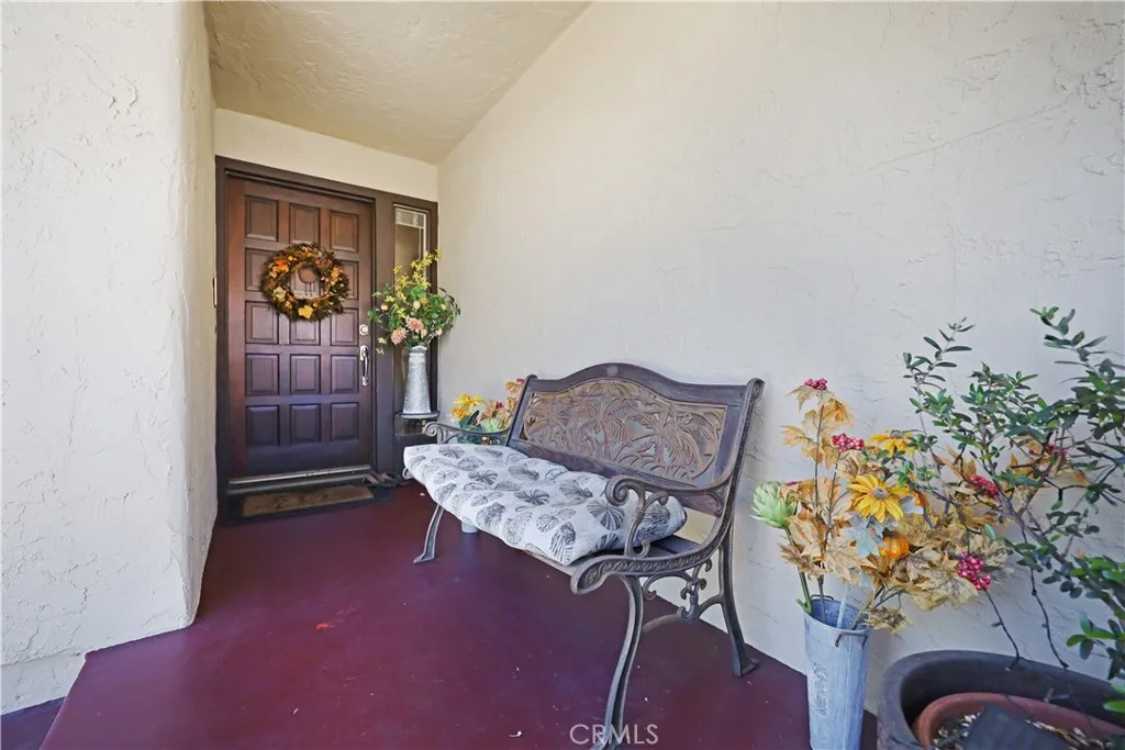 Welcoming front entry with decorative double doors, covered porch, and space for seasonal décor