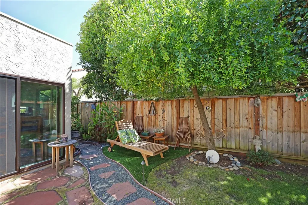 Backyard with mature trees, open patio space, and room to personalize your outdoor retreat