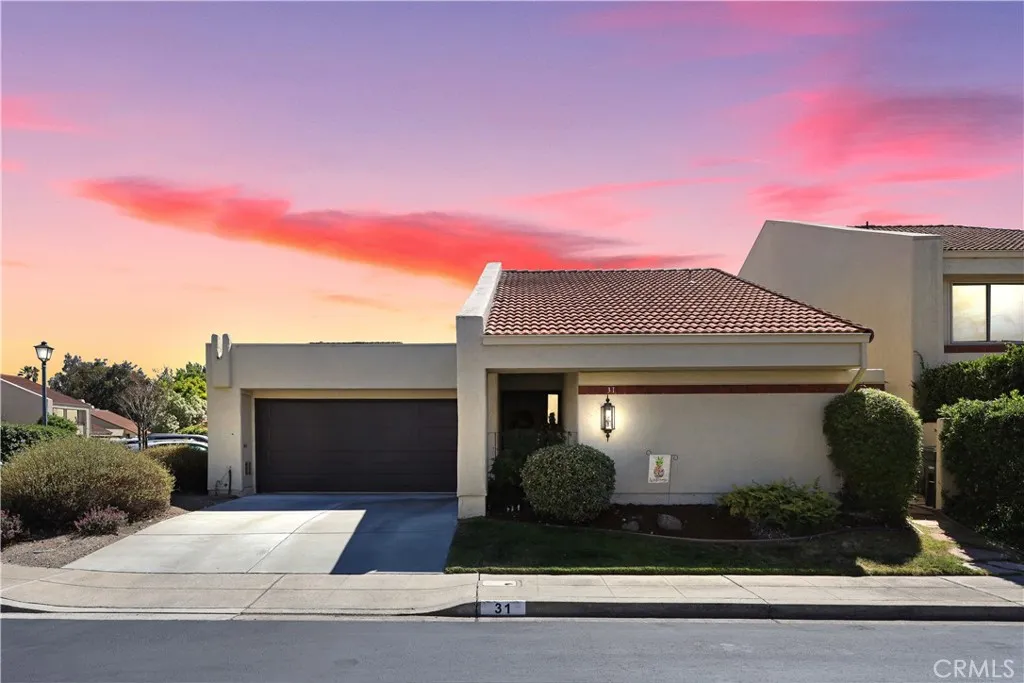 Another inviting twilight exterior view that highlights the home's welcoming entry and charming architectural details. (virtually enhanced)