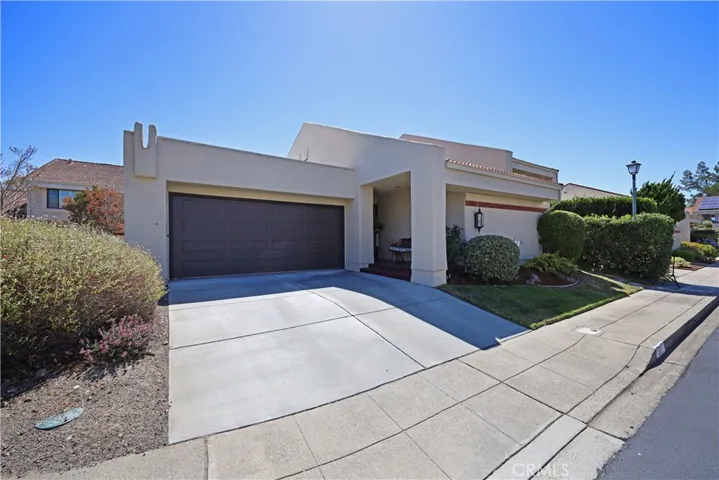 Daytime view of the front of the home showcasing the clean exterior, spacious driveway, and well-kept landscaping.