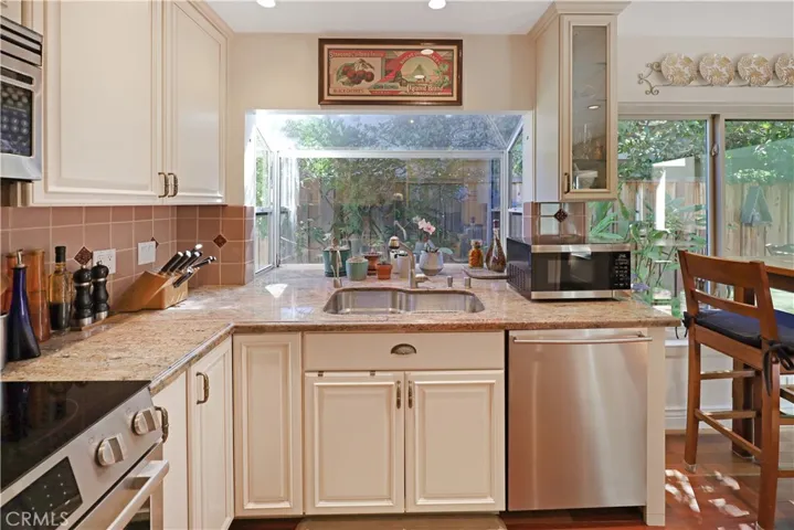 Kitchen view showcasing the functional workspace, breakfast bar, and easy access to the adjoining living areas.