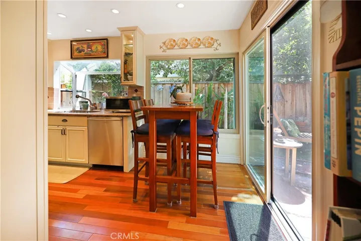 Breakfast area adjacent to the kitchen with large sliding glass doors that bring the outdoors in.