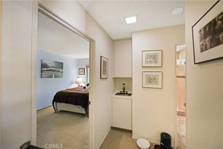 Hallway leading toward the the guest bedroom with clean lines and abundant natural light