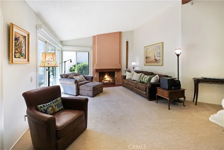 Alternate angle of the living room showcasing the generous layout and large picture windows.