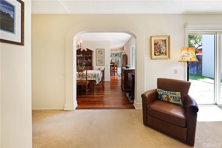 Bright living area featuring comfortable gathering space and seamless connection to adjoining rooms.