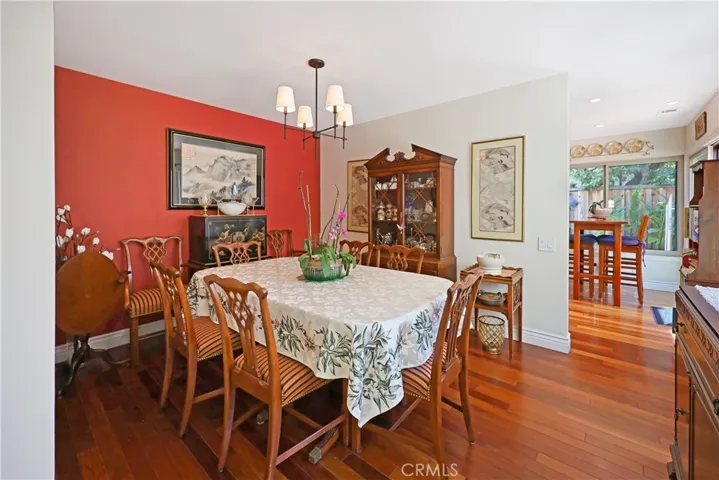 Formal dining room with elegant lighting and plenty of room for hosting family meals and special occasions.