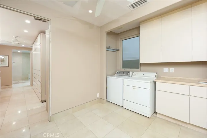 First Floor Laundry Room with entry to Primary Suite Walk-In Closet