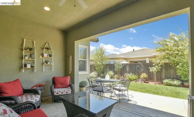Covered patio with concrete flooring, recessed lighting, and an outdoor ceiling fan