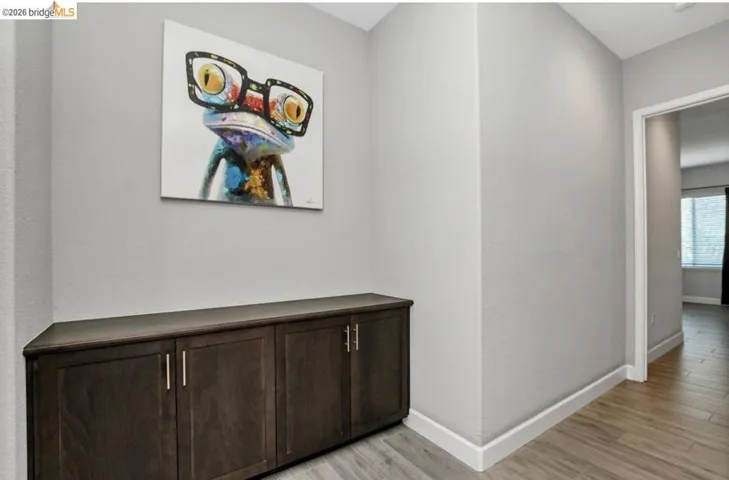 Built-in cabinetry with dark wood-finish doors and brushed nickel hardware, set against light gray walls with white baseboards