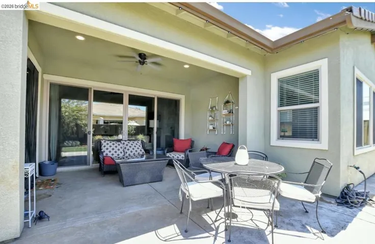 Covered patio with concrete flooring, recessed lighting, and a ceiling fan