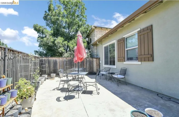 Expansive concrete patio area with a privacy fence