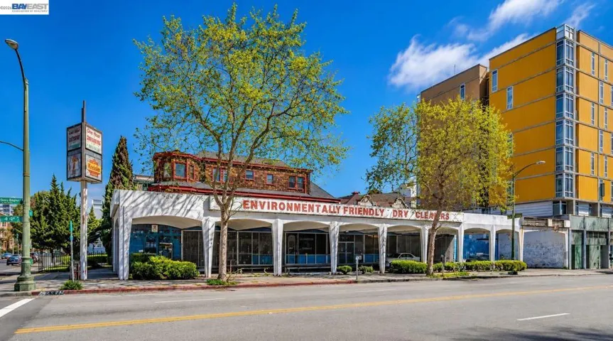 Exterior view of the property showing existing dry-cleaner façade and storefront