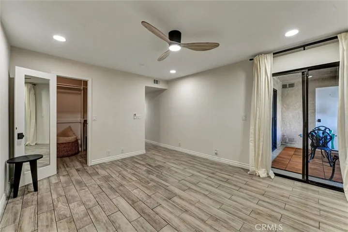 Primary bedroom has two closets and leads to balcony.