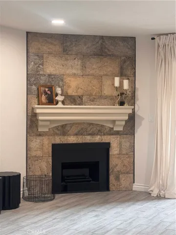 Beautiful tiled fireplace with with custom wood mantle.