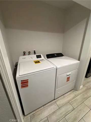 Laundry closet with full sized washer and dryer.