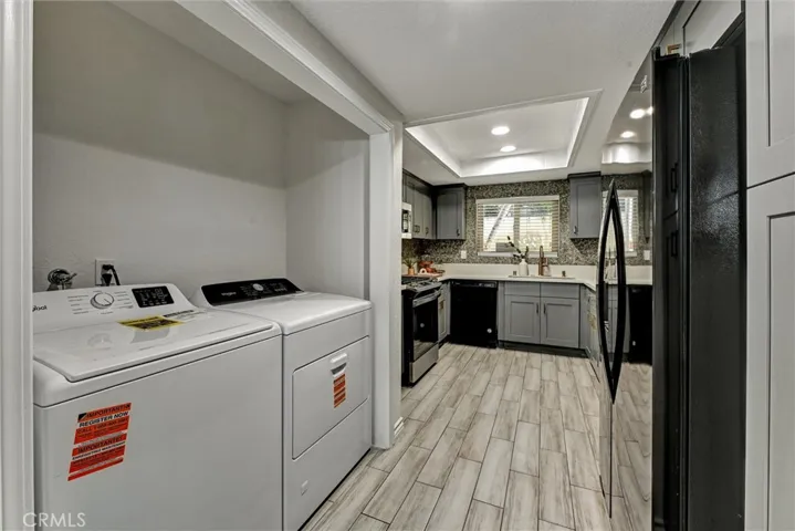 Laundry closet with full sized washer and dryer.