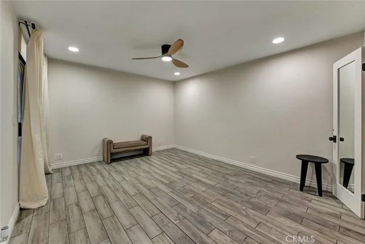 Primary bedroom has two closets and leads to balcony.