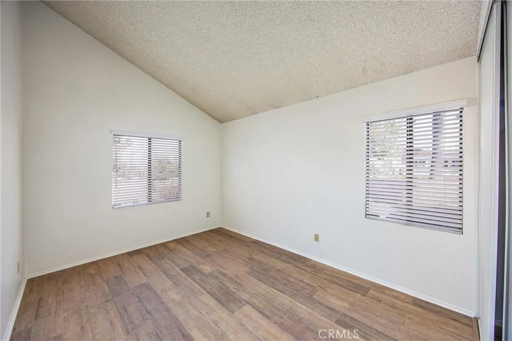 Spacious bedroom with dual windows that fill the room with natural light