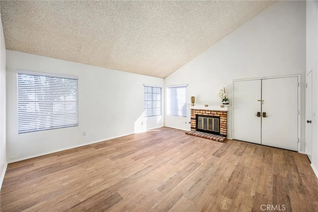 Expansive living room with oversized windows and fireplace