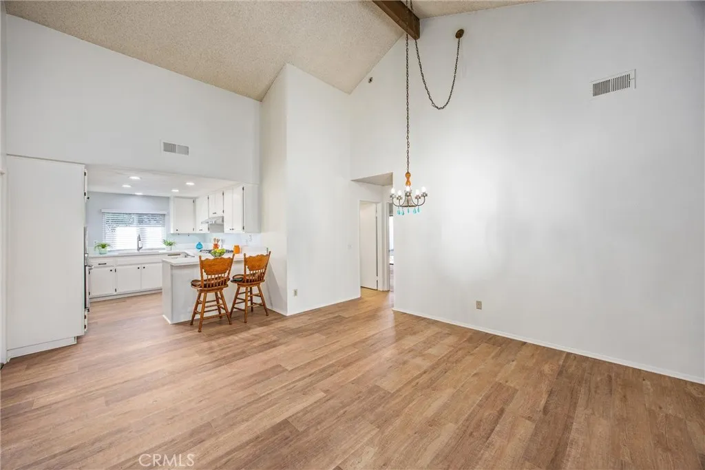 Formal dining room with impressive ceiling height and seamless flow to the kitchen