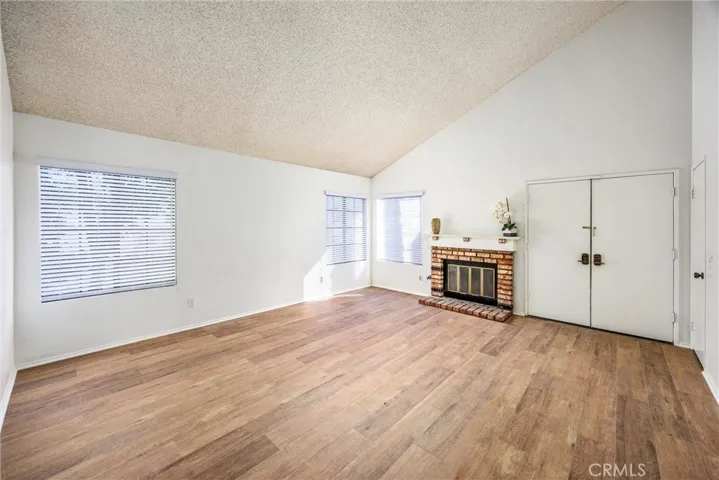 Expansive living room with oversized windows and fireplace
