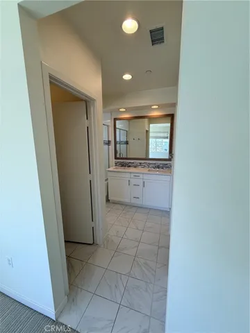 Primary Bathroom w/ toilet and walk-in closet