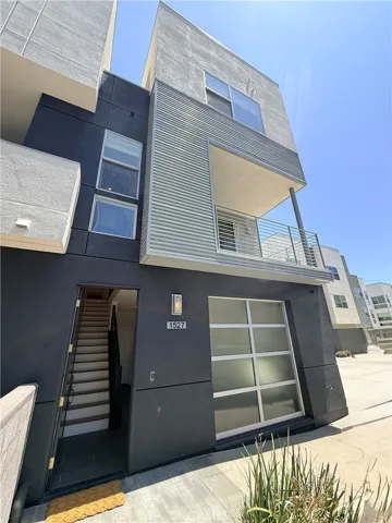 End Unit with front door entrance and roll up garage door