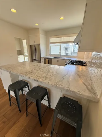 Looking from the dining room into the kitchen