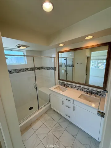 Primary bathroom with double sinks and walk-in shower