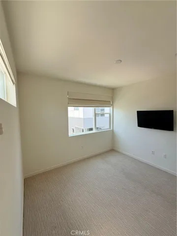 3rd floor secondary bedroom w/ TV and carpet