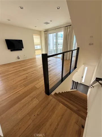 second floor landing in family room with stairs going down to first floor