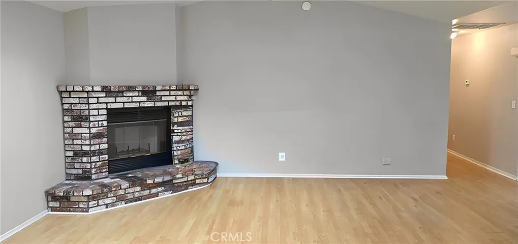 Virtually enhanced Living room with woodburning fireplace with brick surround