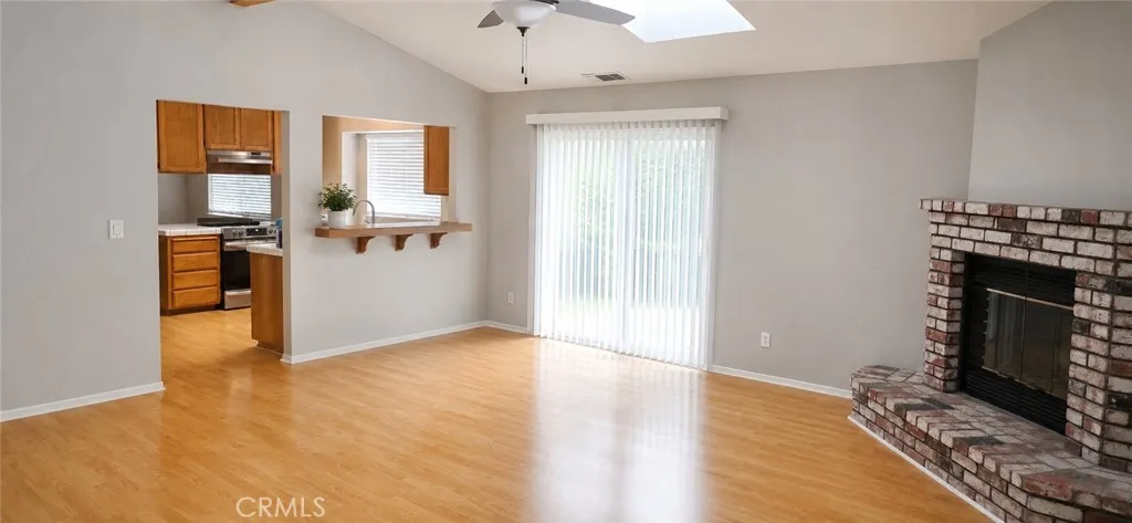 Virtually enhanced Living room with vaulted ceilings and skylight