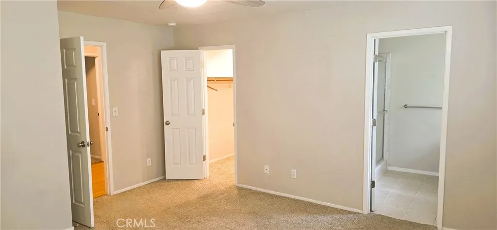 Primary bedroom features walk-in closet and private bathroom