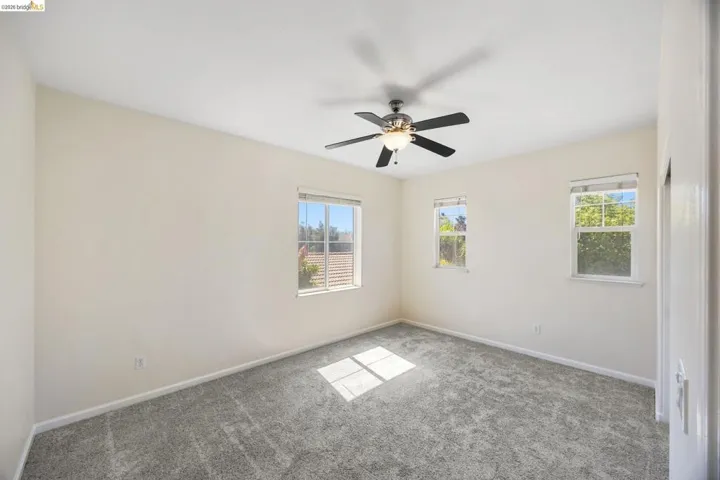 Neutral-toned walls complement the gray carpeting