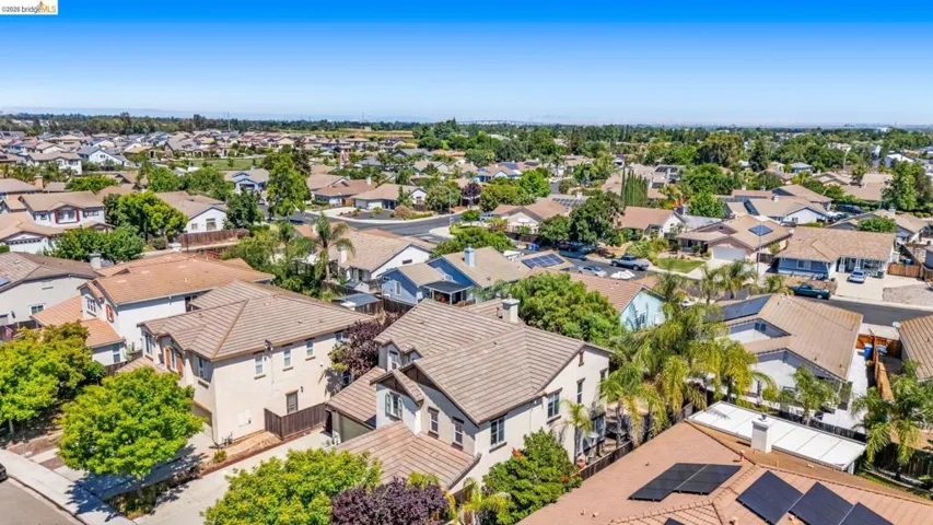 Expansive residential neighborhood featuring a mix of single-family homes, mature landscaping, and clear skies