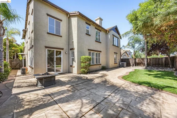 Stucco exterior with brown trim windows and a tiled roof