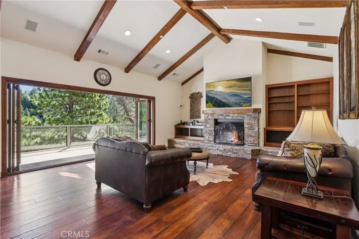 Living room leads to covered entertaining deck