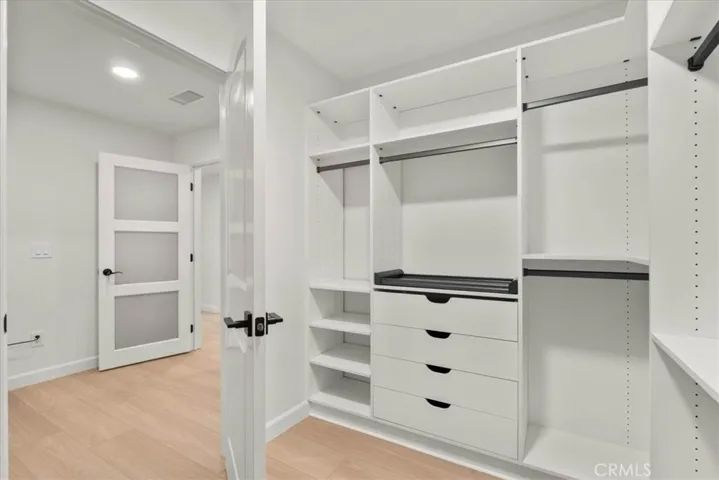 primary closet with custom organizers