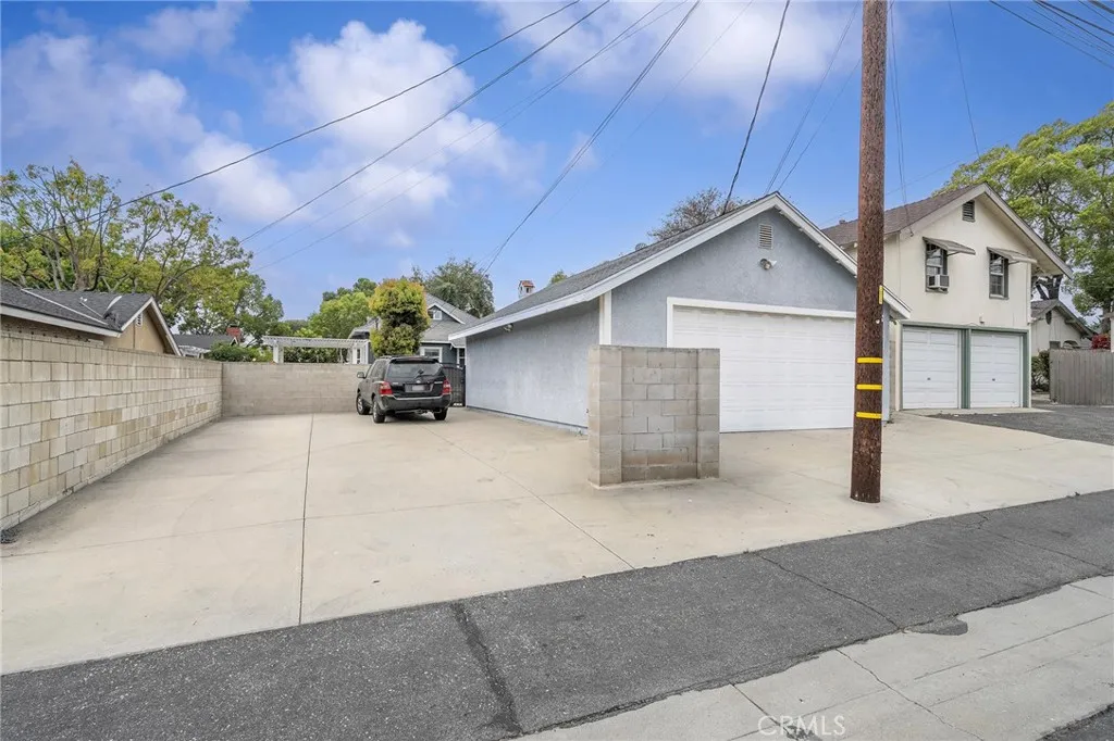 Paved parking pad adjacent to the garage