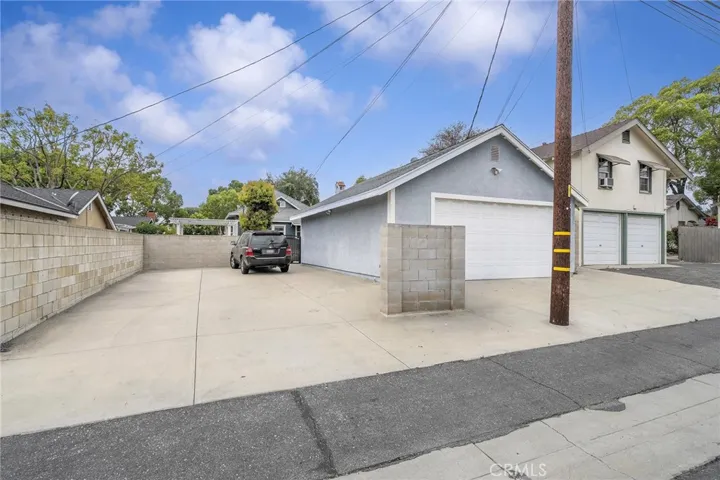 Paved parking pad adjacent to the garage