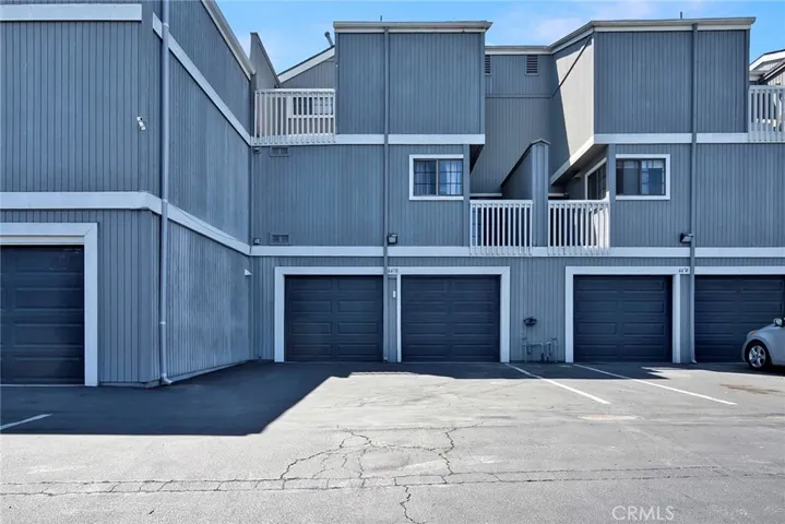 two car garage with parking in front of it