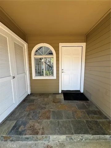 Storage closet for trash bins on left.