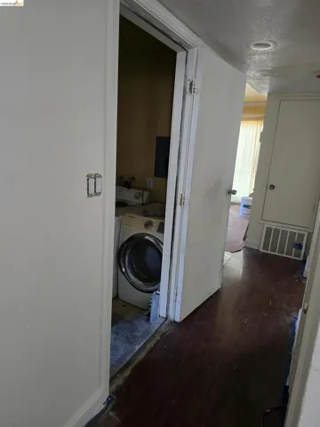 Laundry area featuring a front-loading washer and adjacent dryer connection