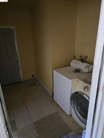 Tile flooring in a utility space with a side-by-side laundry appliance setup